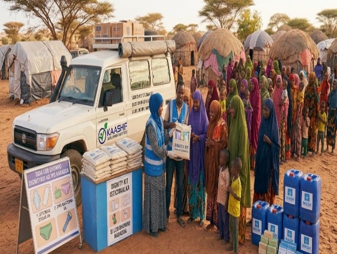 KDI staff distributing dignity kits and water containers to women at a displacement site